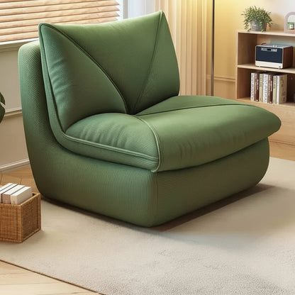 Fauteuil pouf salon en velours côtelé vert olive dans un intérieur chaleureux