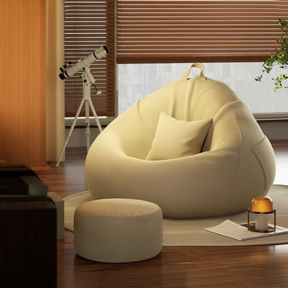 Pouf poire géant crème avec repose-pieds présenté dans un salon chaleureux