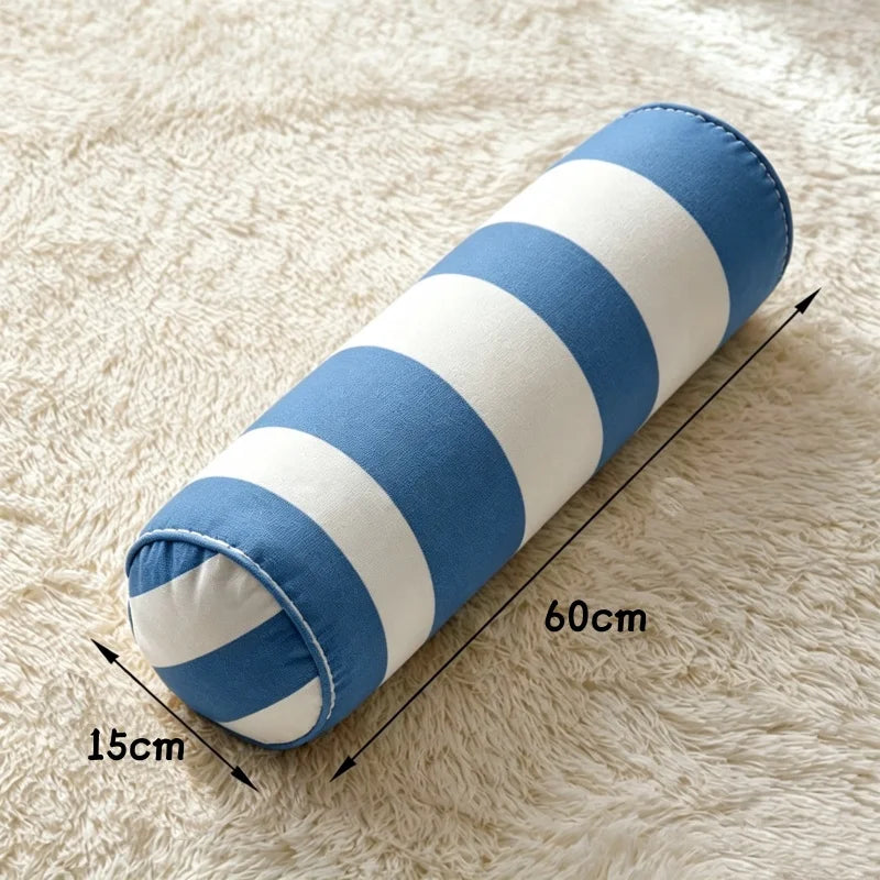 Coussin cylindrique à rayures bleues et blanches, de 60 cm de longueur et 15 cm de diamètre.