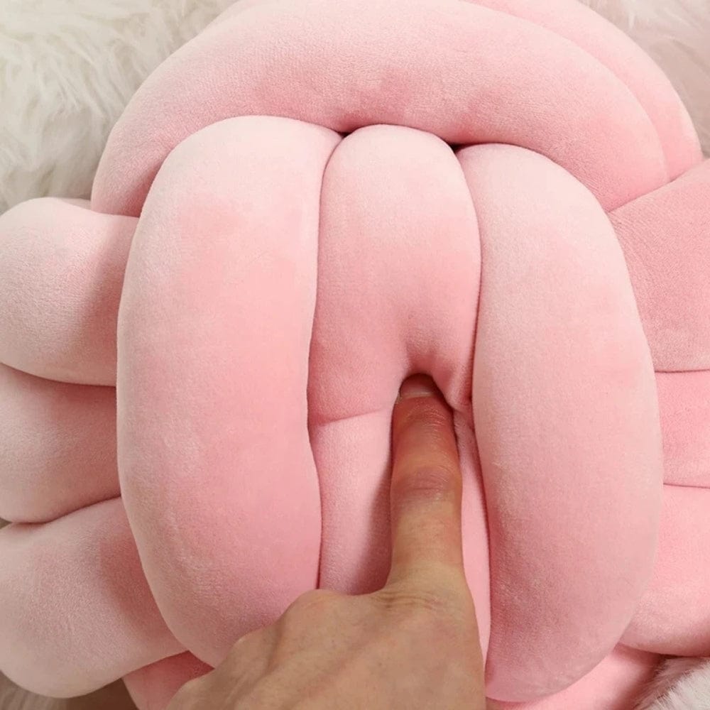 Coussin décoratif en velours rose en forme de nœud, idéal pour un canapé ou un lit