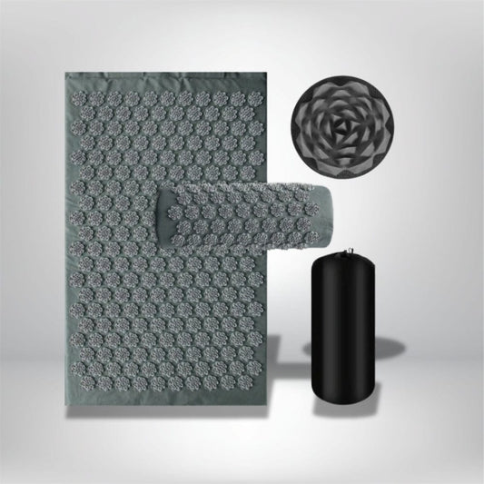 Coussin d'acupression gris avec motifs en relief, posé sur un fond neutre, idéal pour un coin détente