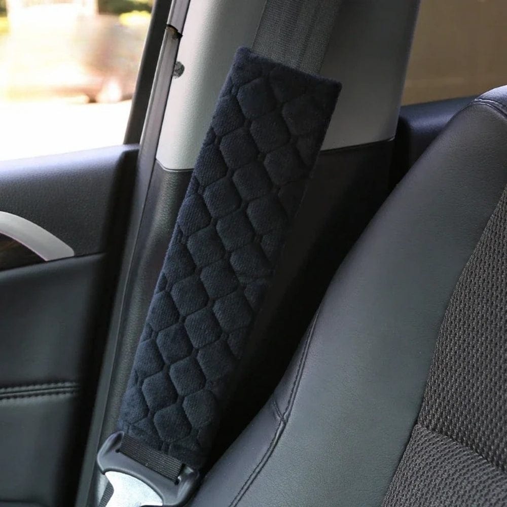 Coussin de ceinture de sécurité en velours noir avec un motif hexagonal, installé sur un siège de voiture