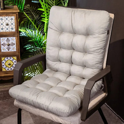 Coussin de chaise en velours gris, rembourré avec un motif matelassé, posé sur une chaise moderne dans un salon