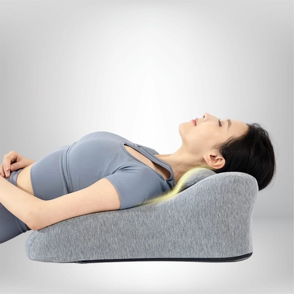 Coussin de lecture gris en forme ergonomique, posé sur un fond neutre, idéal pour un confort optimal