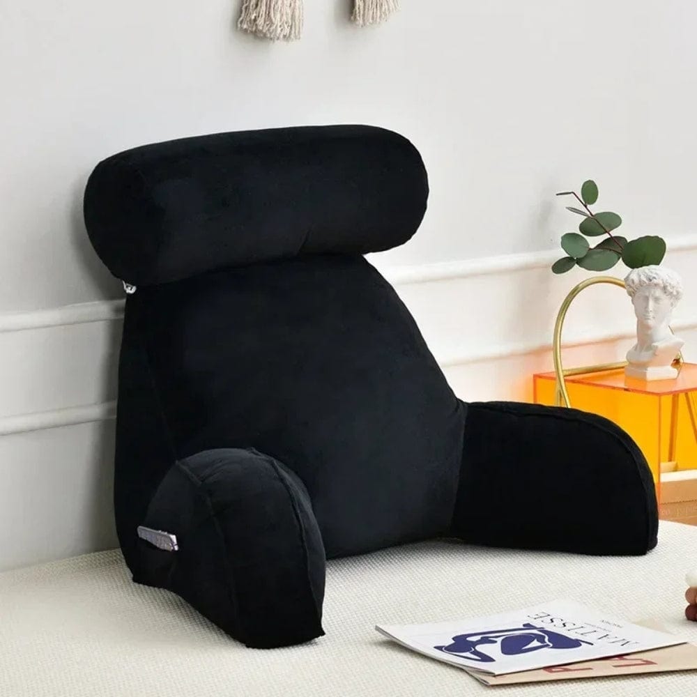 Coussin de lecture noir en velours, soutenant le dos sur un lit, avec des accoudoirs confortables