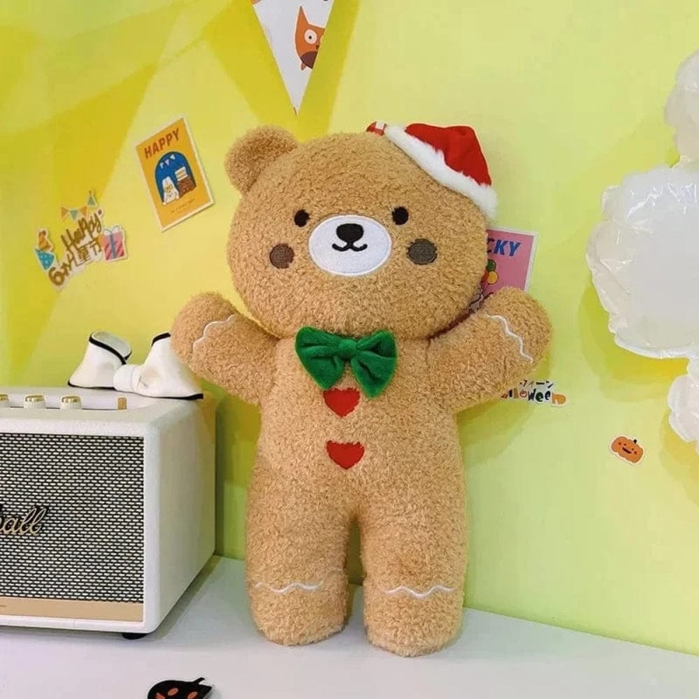 Coussin décoratif en forme d'ours en peluche, couleur beige, avec un chapeau de Noël et un nœud vert