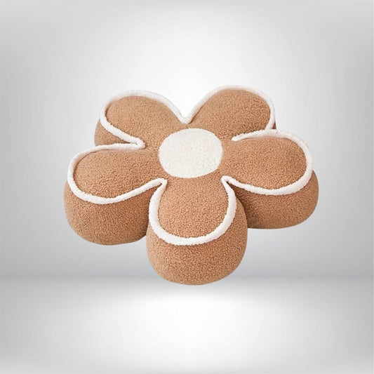 Coussin de sol en forme de fleur, couleur beige avec un centre blanc, posé sur un fond neutre
