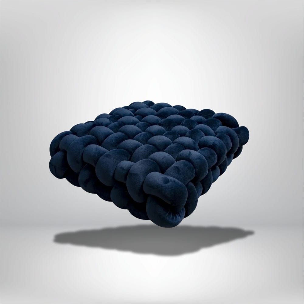 Coussin déco en velours bleu nuit, design moderne, posé sur un fond neutre, évoquant confort et élégance