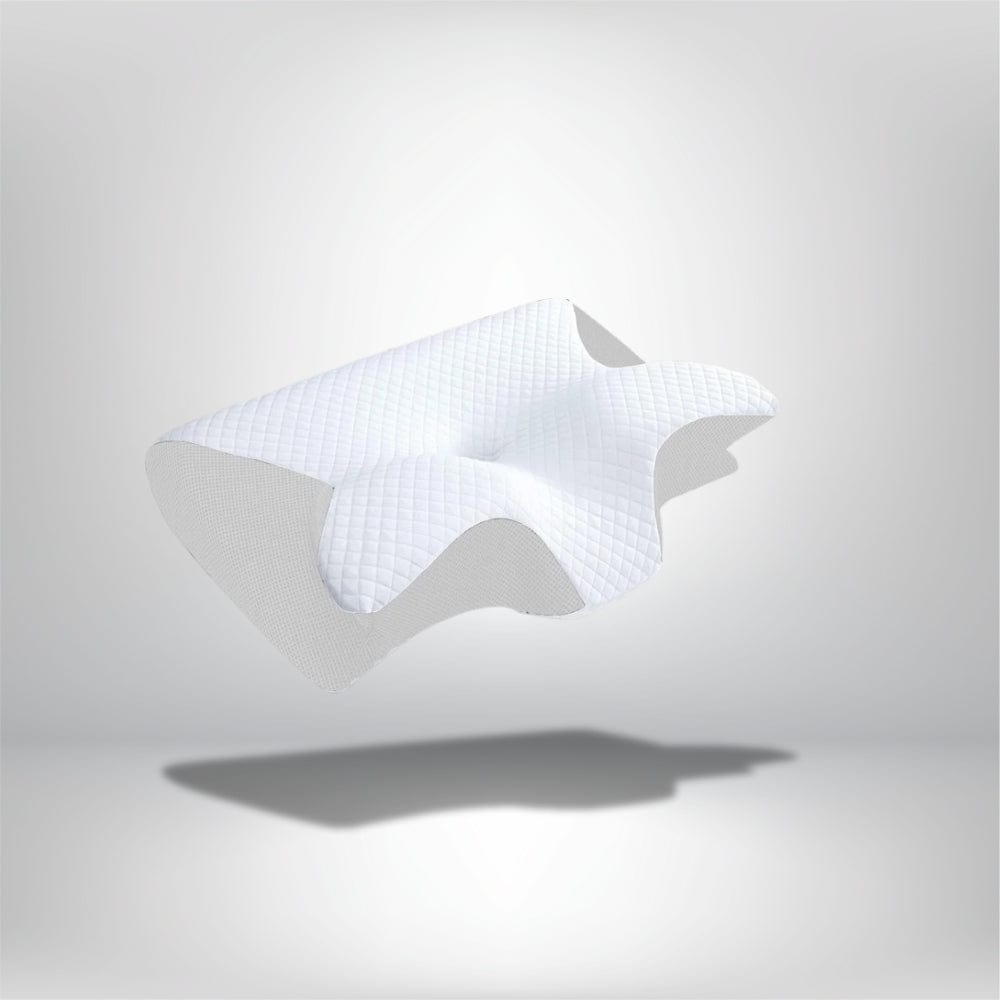 Coussin ergonomique blanc avec un motif en relief, posé sur un fond neutre, idéal pour un confort optimal