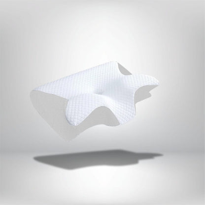 Coussin ergonomique blanc avec un motif en relief, posé sur un fond neutre, idéal pour un confort optimal