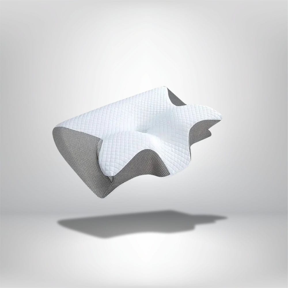 Coussin ergonomique blanc avec motif matelassé, posé sur un fond gris, idéal pour le confort du nuque