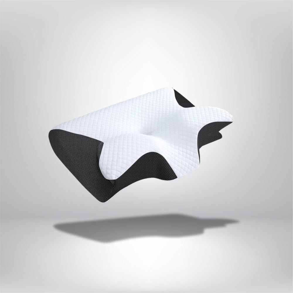 Coussin ergonomique de couleur blanche et noire, avec un motif en relief, posé sur un fond neutre