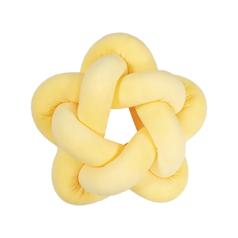 Coussin déco en forme d'étoile jaune, idéal pour embellir un canapé ou une chambre d'enfant