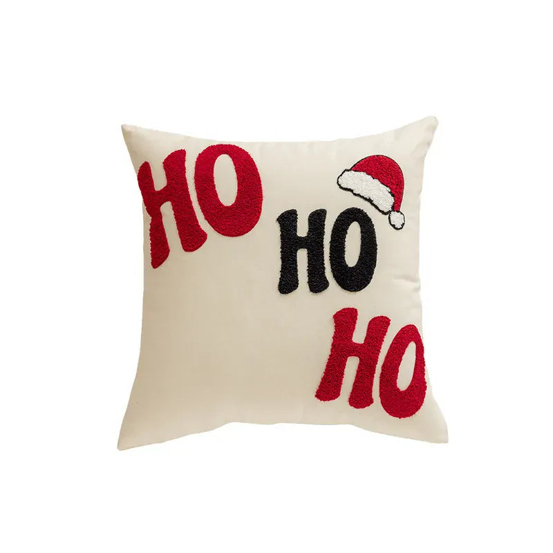 Coussin décoratif beige avec broderie rouge et noire "HO" et un bonnet de Noël, idéal pour le canapé