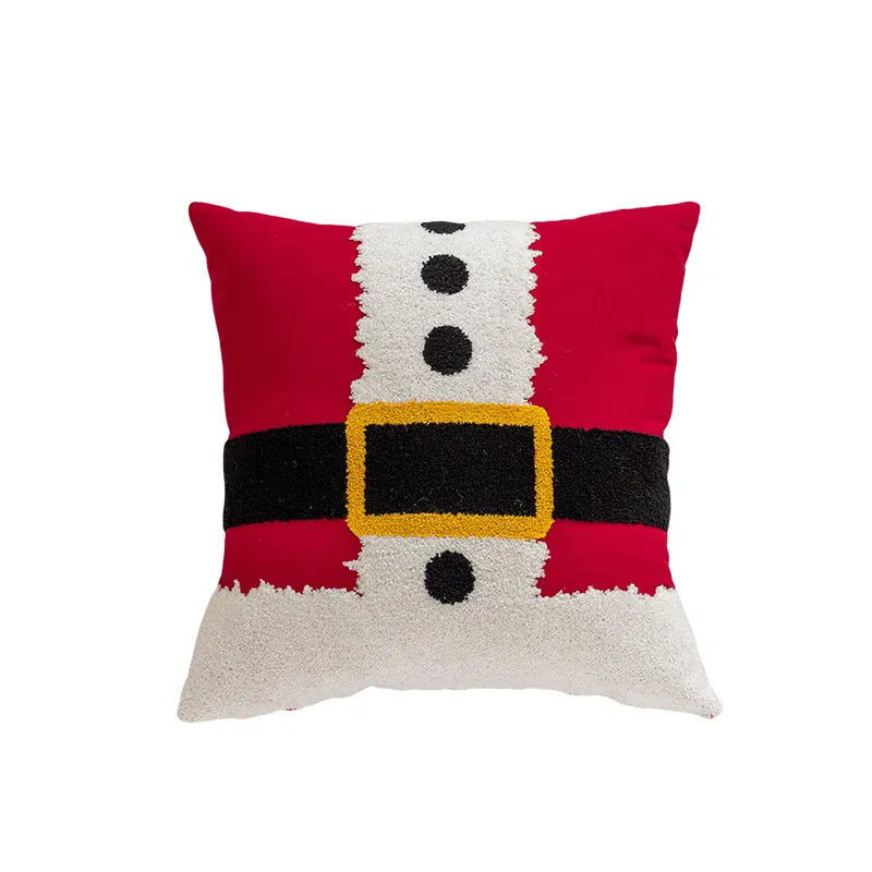 Coussin décoratif rouge avec motif de costume de Père Noël, posé sur un canapé pour une ambiance festive