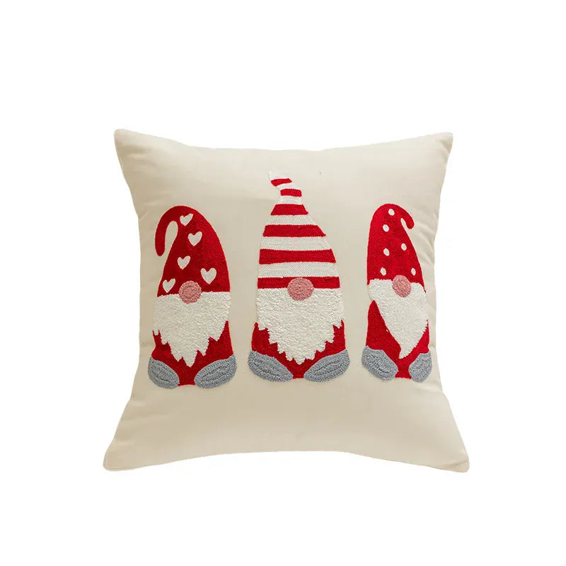 Coussin décoratif beige avec motifs de lutins rouges et blancs, idéal pour un canapé ou un lit festif