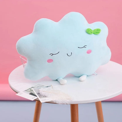 Coussin décoratif en forme de nuage bleu, doux, avec des détails souriants, posé sur une table en bois