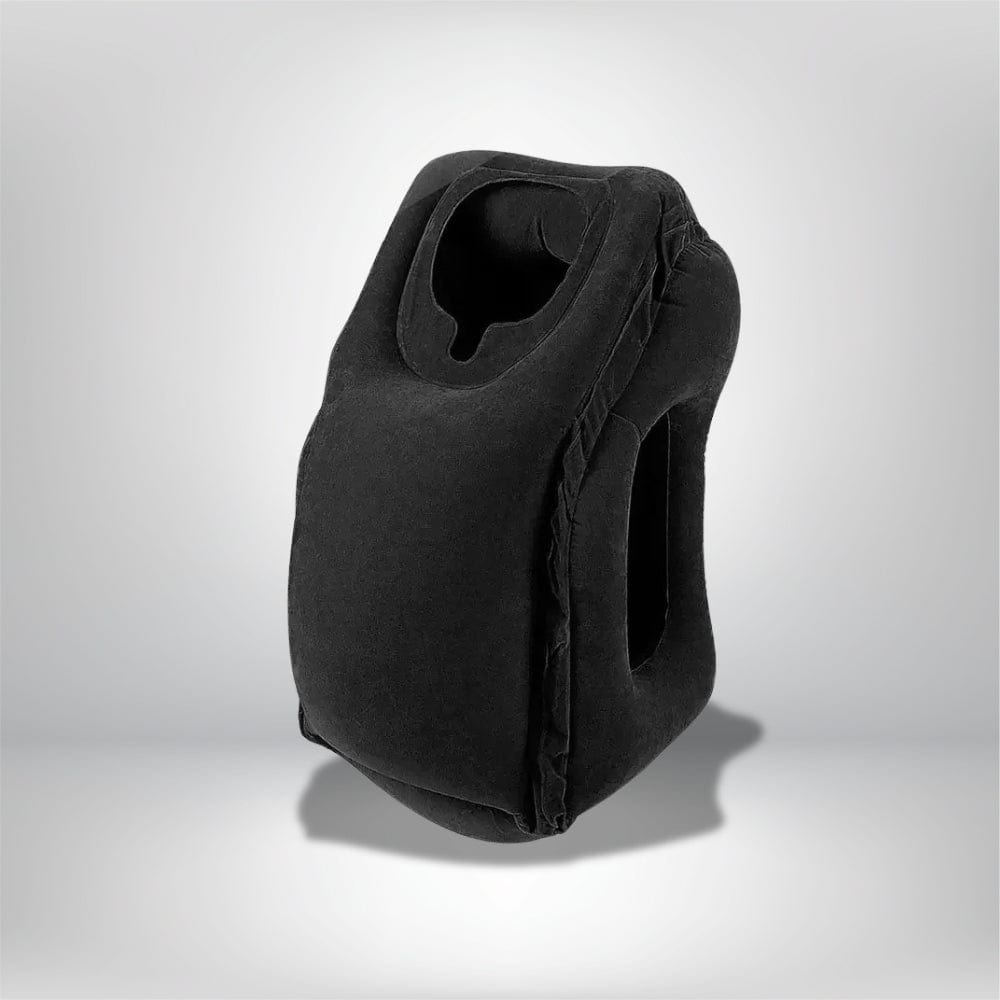 Coussin de voyage noir en velours avec ouverture pour le cou, posé sur une surface neutre