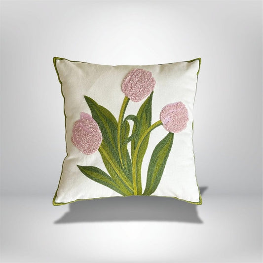 Coussin décoratif en coton blanc avec motifs de tulipes roses et feuillage vert, idéal pour un canapé