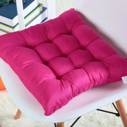 Coussin de chaise de jardin en tissu fuchsia, rembourré avec des coutures décoratives, posé sur une chaise blanche