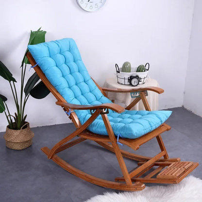 Coussin décoratif bleu en tissu matelassé sur un rocking chair en bois dans un salon moderne
