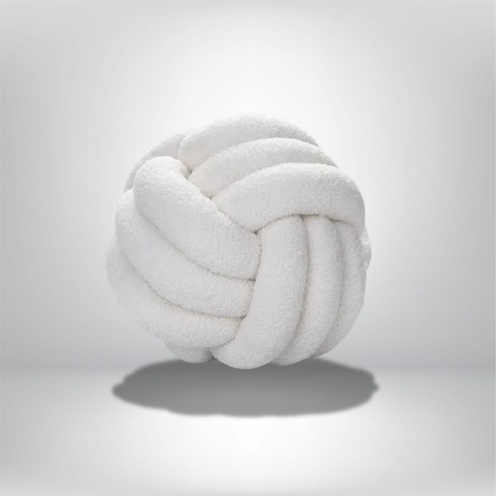 Coussin rond en peluche blanche, décoratif, posé sur une surface neutre, ajoutant une touche douce et moderne à votre intérieur