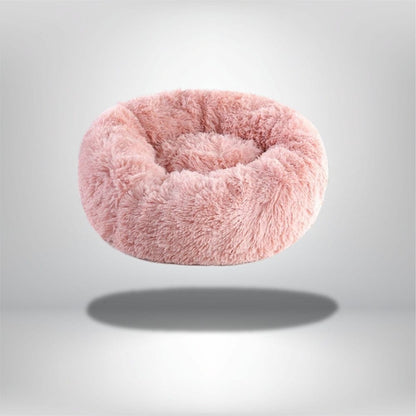 Coussin rond en fausse fourrure rose, idéal pour le confort d'un chat dans un salon ou une chambre