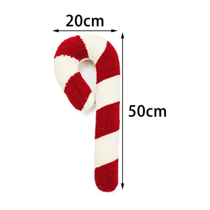 Coussin décoratif en forme de sucre d'orge, rouge et blanc, posé sur un canapé moderne