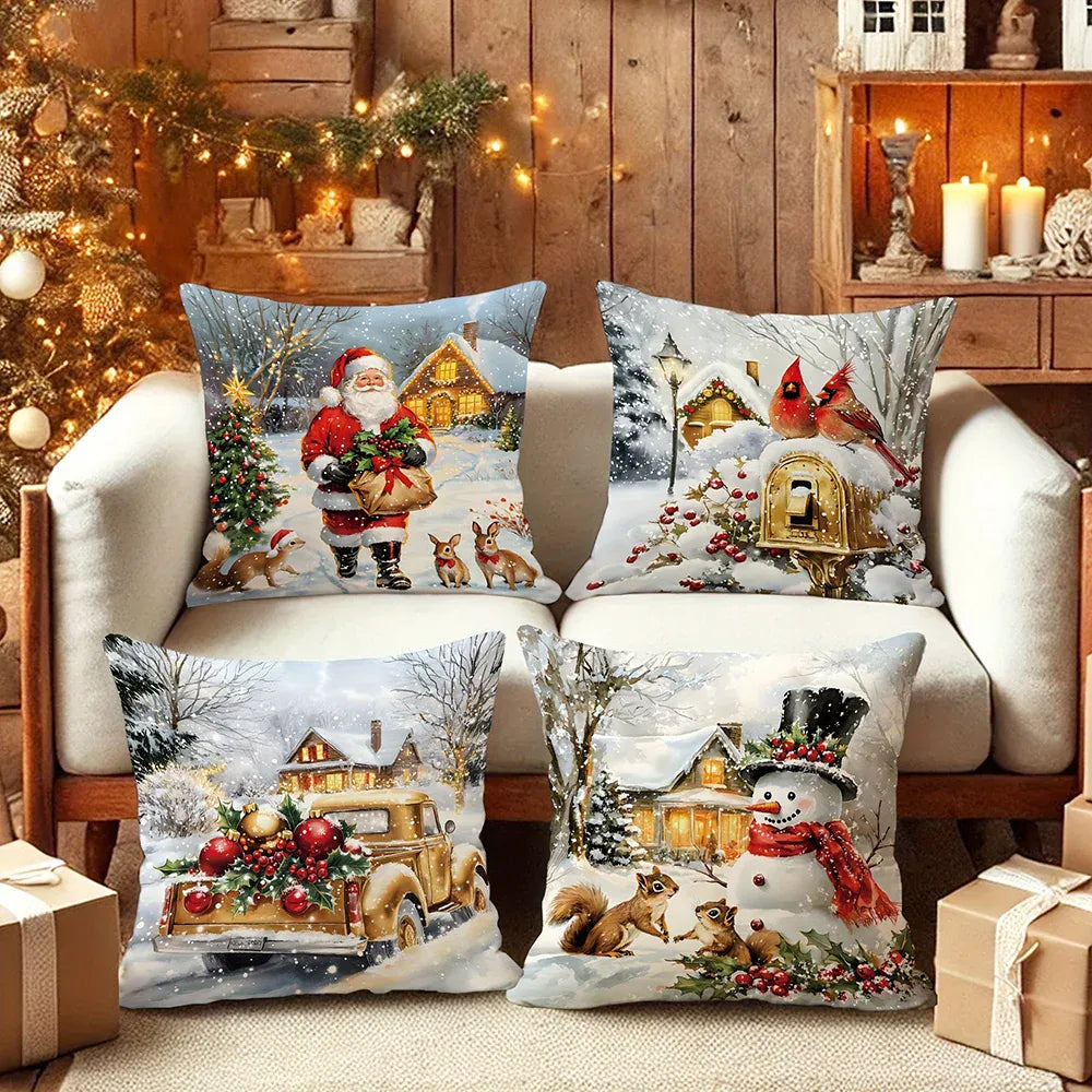 Quatre coussins décoratifs aux motifs de Noël, illustrant un père Noël, un bonhomme de neige et des paysages enneigés sur