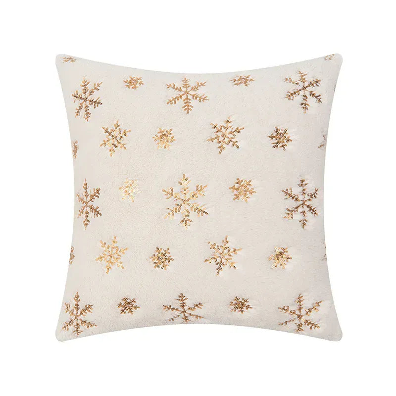 Housse de coussin décoratif beige avec motifs flocons de neige dorés, idéal pour un canapé élégant
