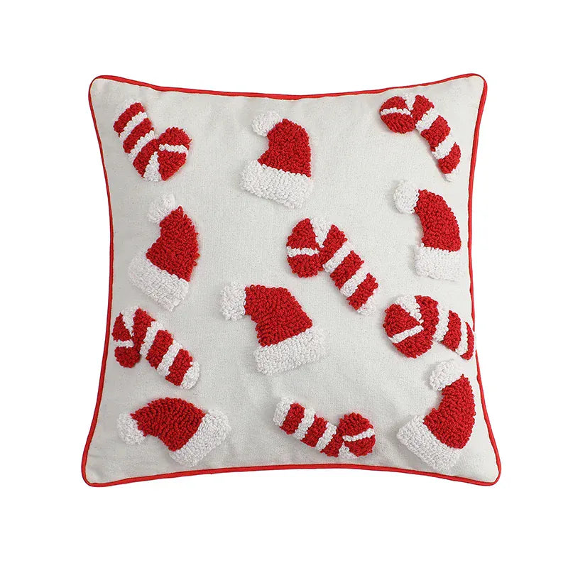 Coussin décoratif en tissu blanc avec motifs de bonnets de Noël rouges et cannes en sucre, idéal pour un salon