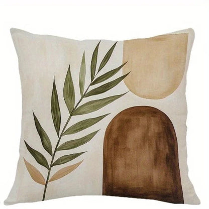 Housse de coussin décoratif avec motifs géométriques en couleurs naturelles, posée sur un canapé moderne