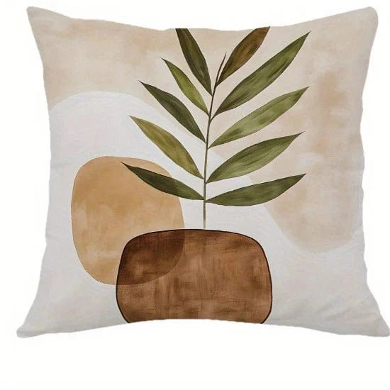 Housse de coussin décoratif avec motifs géométriques aux tons naturels, posé sur un canapé beige