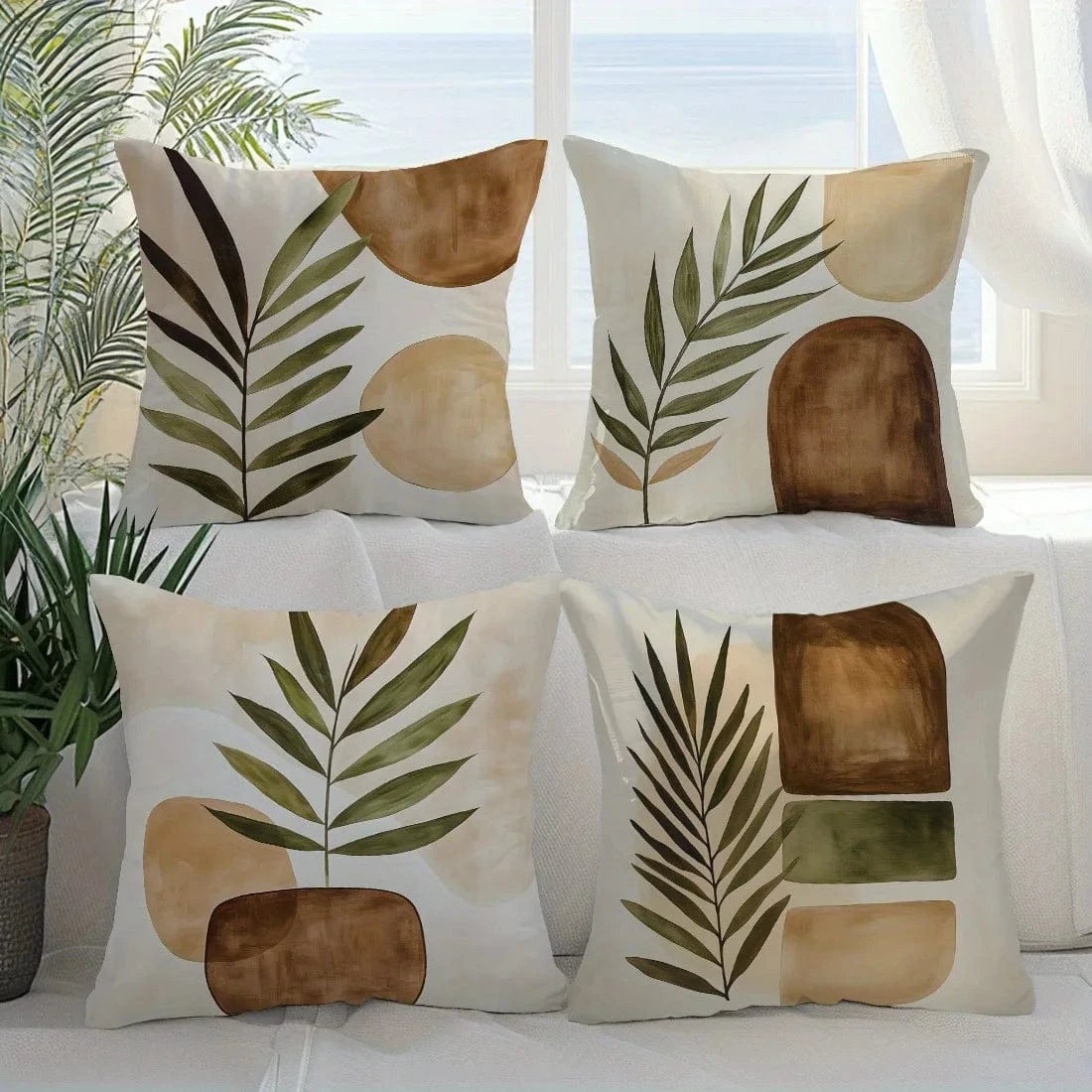 Coussins décoratifs aux motifs géométriques naturels, couleurs terre et vert, disposés sur un canapé lumineux