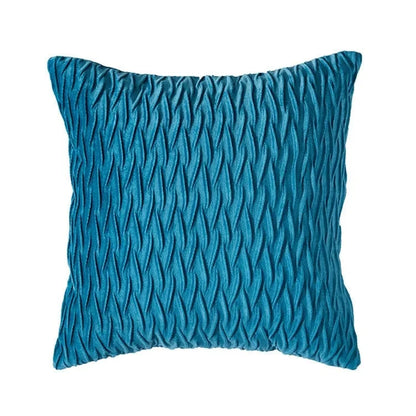 Coussin décoratif en velours bleu avec un motif texturé, parfait pour un canapé moderne et élégant