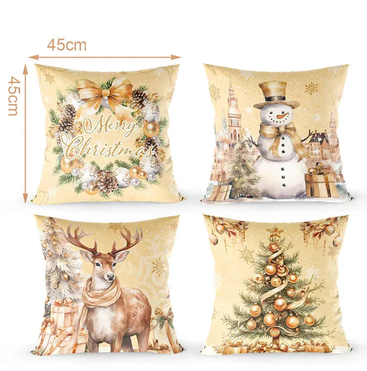 Quatre coussins décoratifs aux motifs de Noël, avec des couleurs dorées et des illustrations de renne, bonhomme de neige, sapin