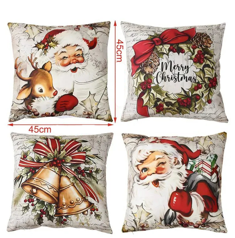 Quatre coussins décoratifs avec motifs de Noël, représentant le Père Noël, un renne et des cloches, sur un canapé