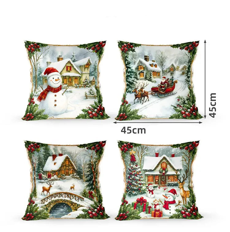 Quatre coussins décoratifs aux motifs de Noël, représentant un bonhomme de neige, des maisons enneigées et des rennes
