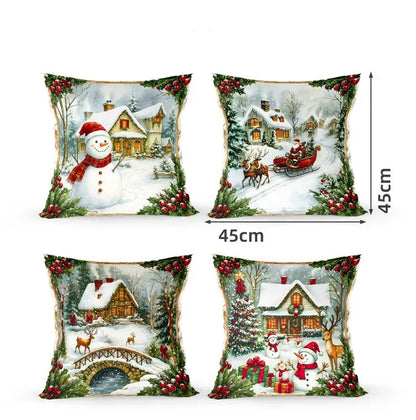 Quatre coussins décoratifs aux motifs de Noël, représentant un bonhomme de neige, des maisons enneigées et des rennes