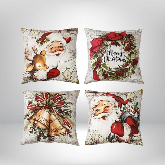 Quatre coussins décoratifs avec des motifs de Noël, représentant le père Noël, un renne et des cloches, sur un fond